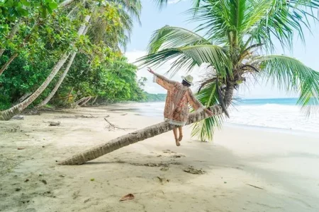 relaxed-woman-beach-palm-tree